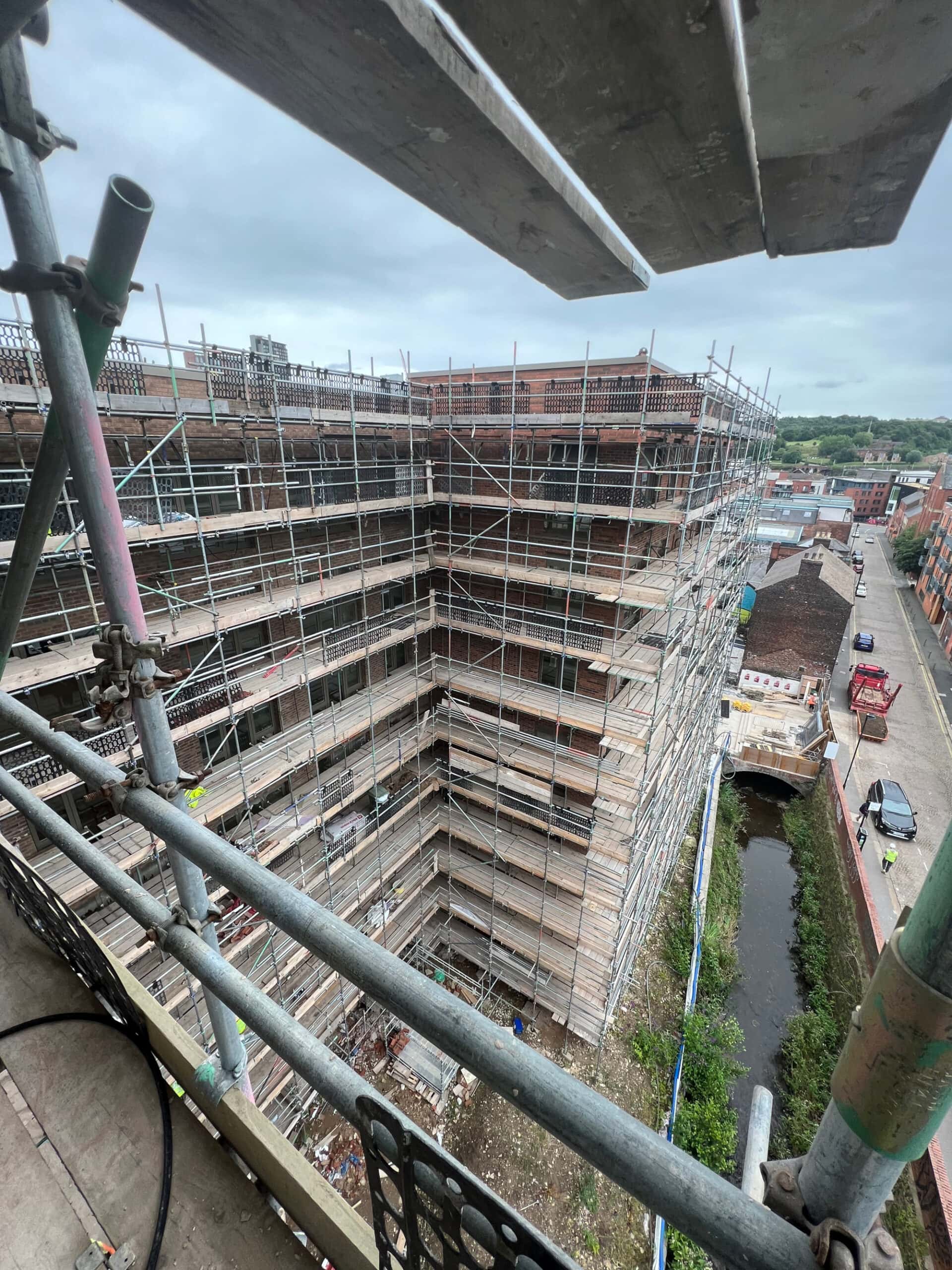 Brick Cleaning Services for Large Scale Projects Scaffolding on exterior of high rise development ready for skilled technitians to clean the exterior bricks.