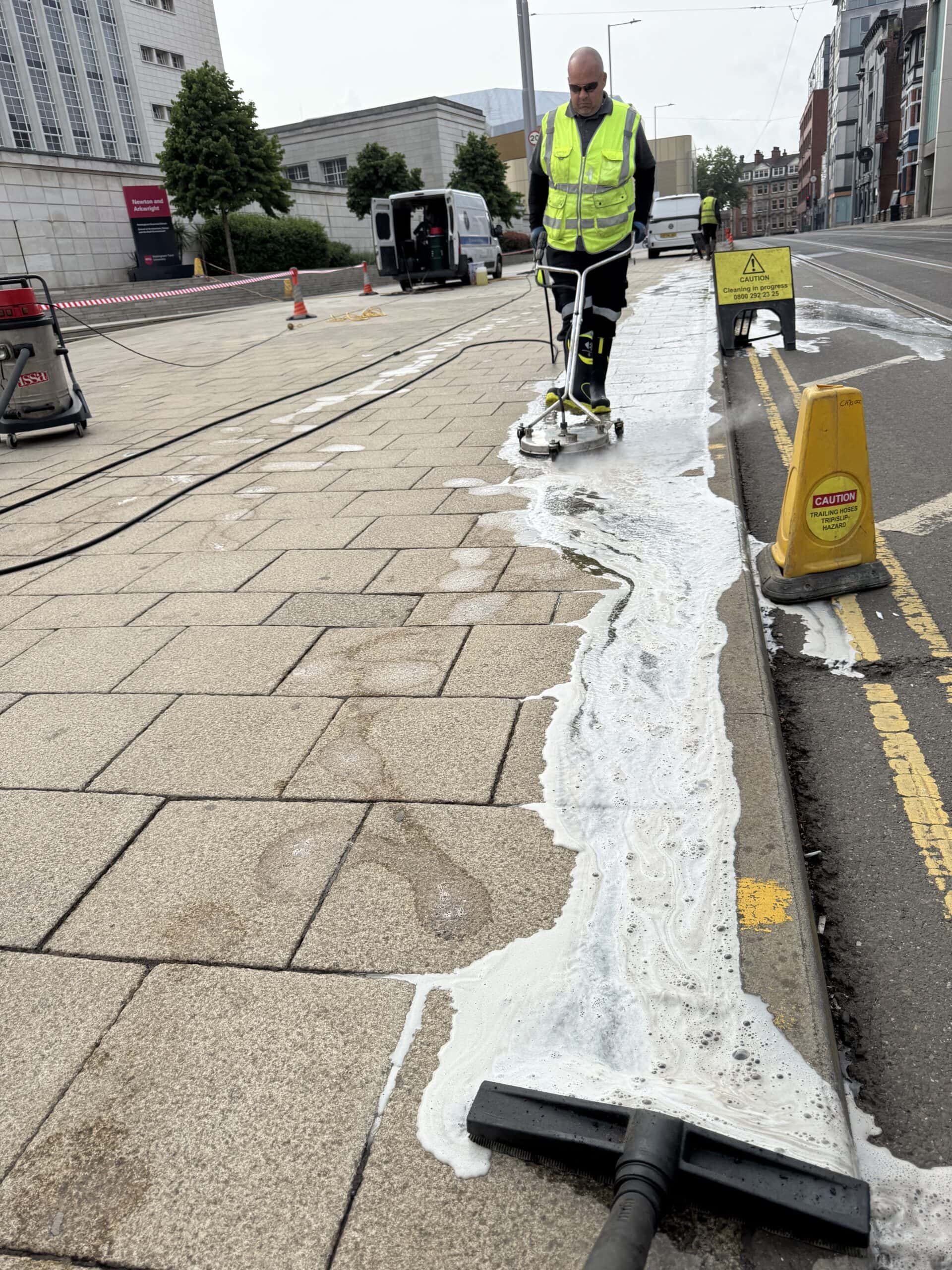 Pressure washing and cleaning of pavement cleaningup oil spill on surface in public areas