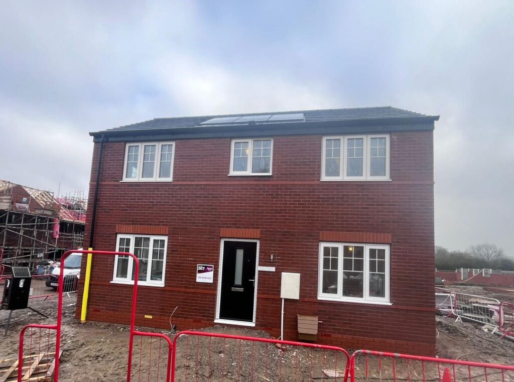 Brick and stone facade cleaning on a new residential building.