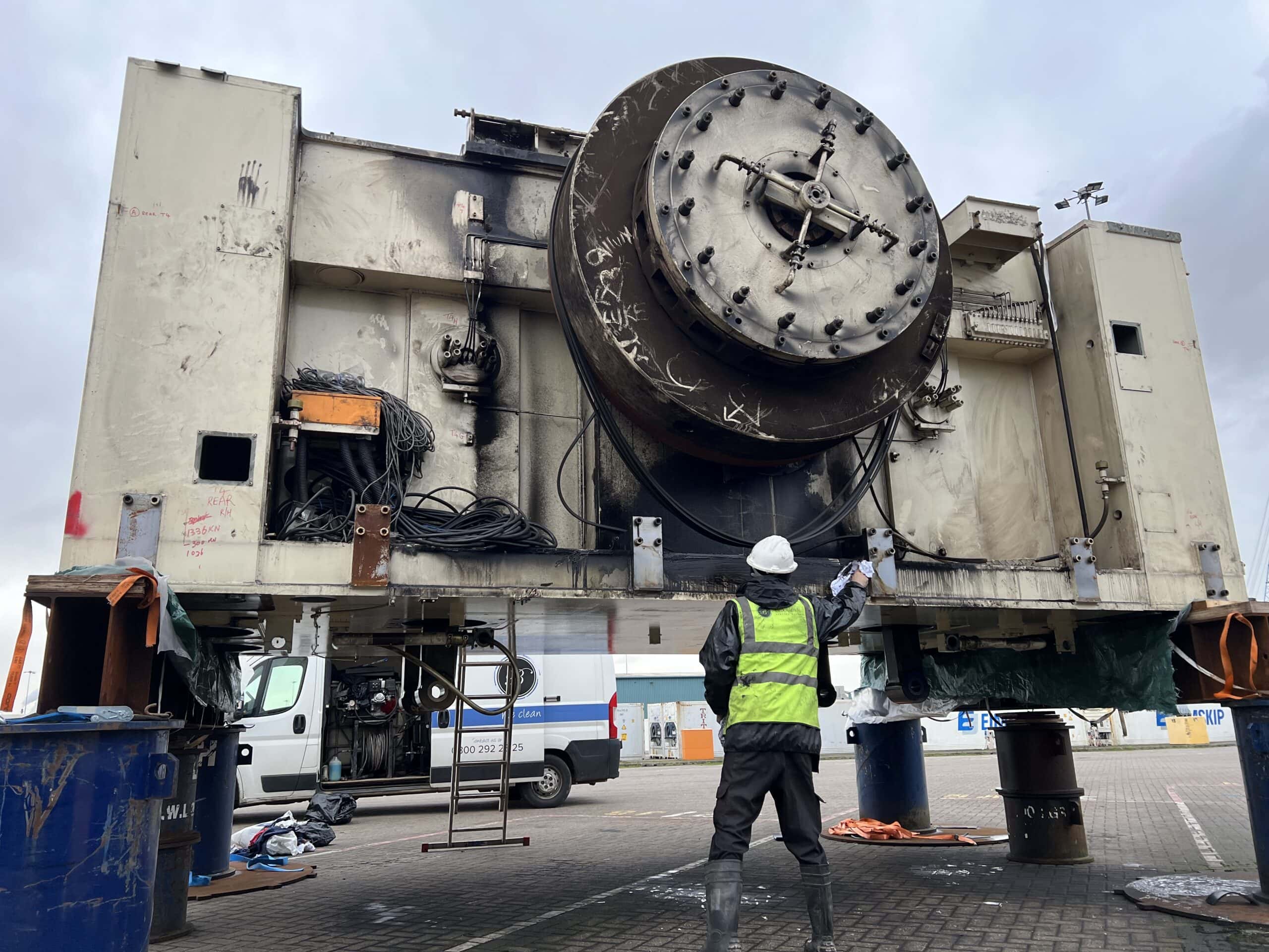 High-pressure cleaning of large industrial machinery for optimal performance and safety.